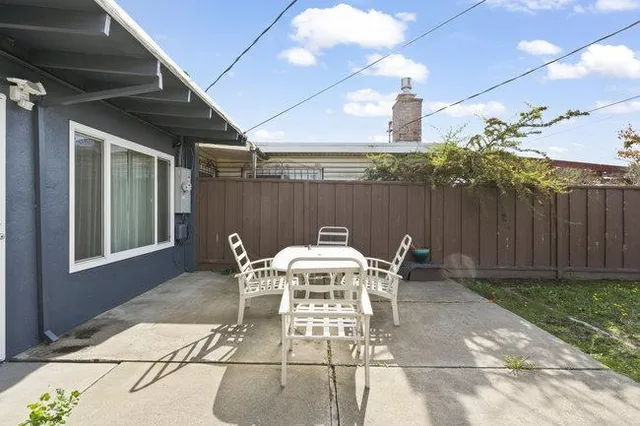 a view of a house with backyard and sitting area