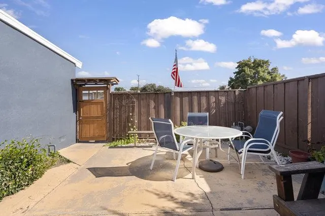 a view of a chairs and table in patio