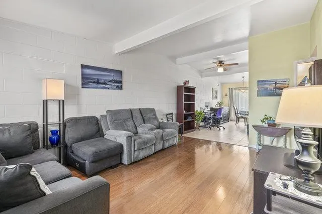 a living room with furniture or couch and a wooden floor