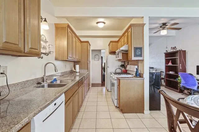 a kitchen with a sink stove and cabinets