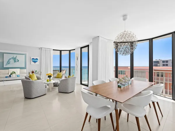 a view of a dining room with furniture a chandelier and wooden floor