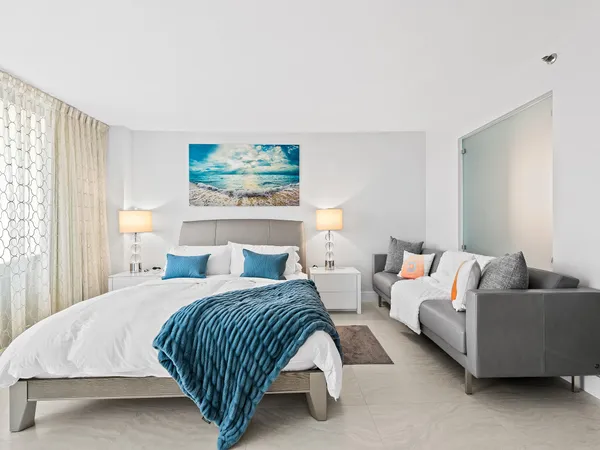 a bedroom with bed and a couch