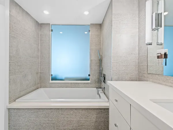 a bathroom with a bathtub and a sink