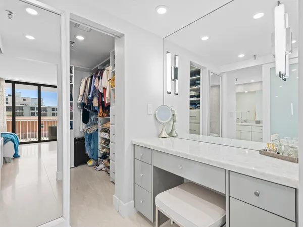 a spacious bathroom with a double vanity sink a mirror and shower