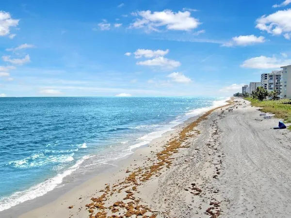 a multi story building with a swimming pool and lawn chairs