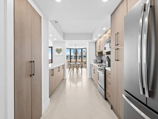a kitchen with stainless steel appliances granite countertop a refrigerator and a stove