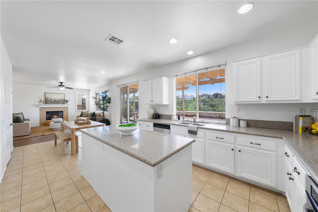 45211 Tioga Street Temecula, CA 92592 - Photo 25 of 78 a kitchen that has a sink and a stove in it