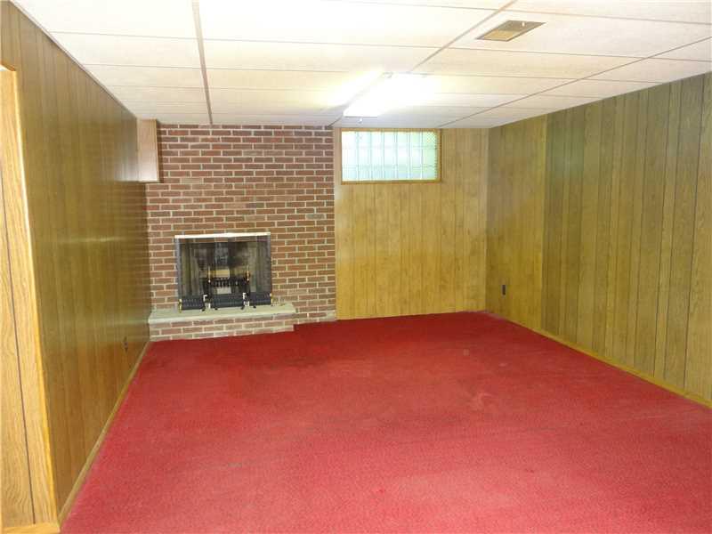 250 Ashbaugh Road Jeannette, PA 15644 - Photo 12 of 15 Family Room. large with a wood burning fireplace..