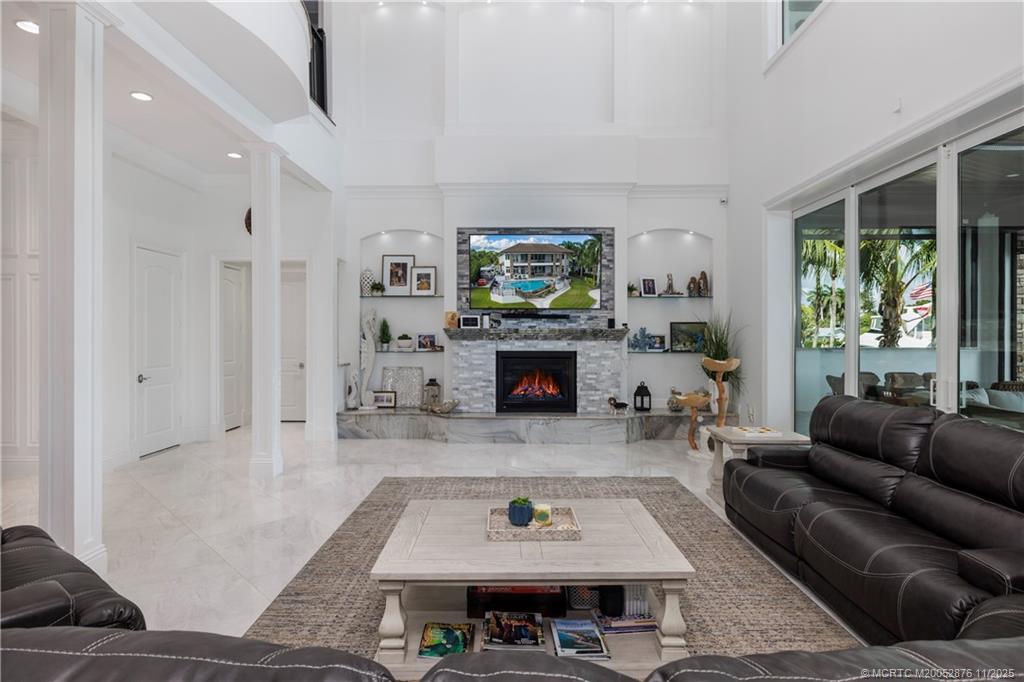 2346 Northwest Fork Road Stuart, FL 34994 - Photo 13 of 100 a living room with furniture a large window and a fireplace