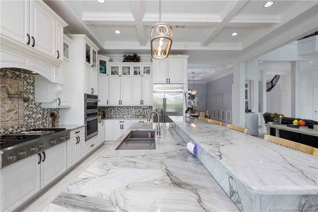 2346 Northwest Fork Road Stuart, FL 34994 - Photo 24 of 100 a large white kitchen with lots of counter space and stainless steel appliances