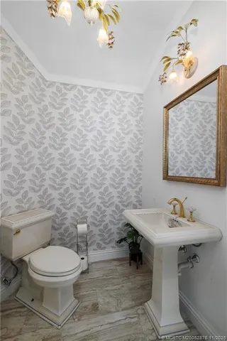 a view of a swimming pool with lawn chairs and a big yard