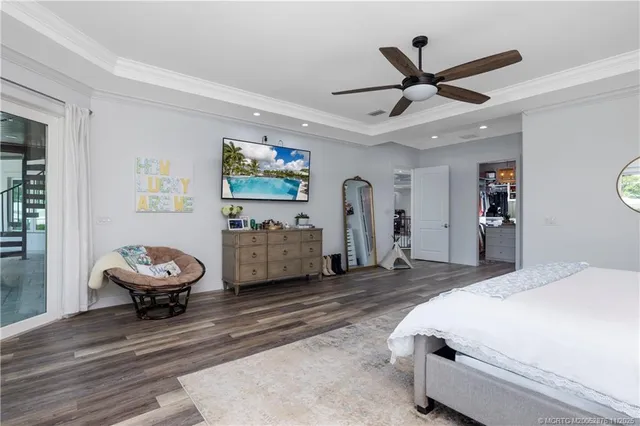 a room with lots of tables a large window and chairs