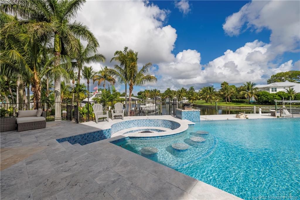 2346 Northwest Fork Road Stuart, FL 34994 - Photo 52 of 100 a view of a swimming pool with a patio and a yard