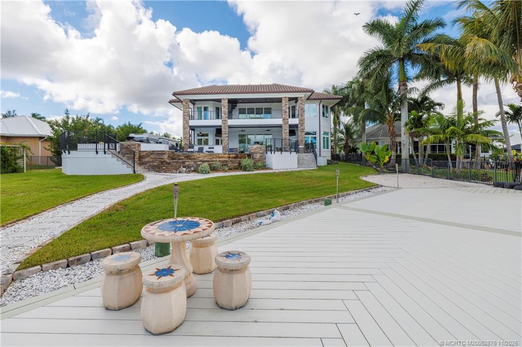 2346 Northwest Fork Road Stuart, FL 34994 - Photo 58 of 100 a view of a house with garden and a bench