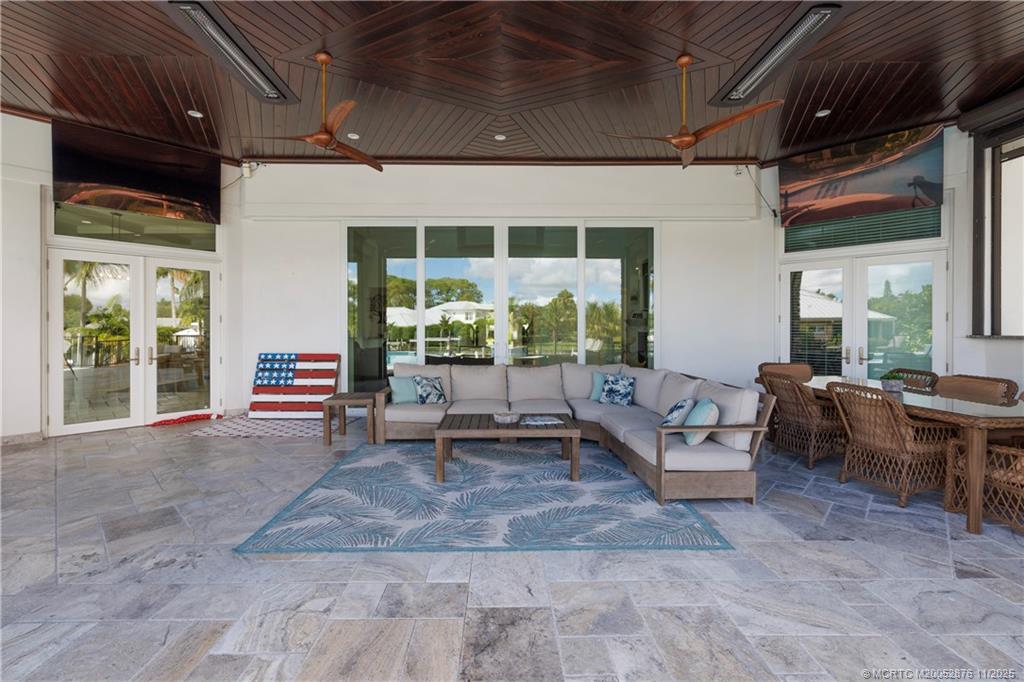 2346 Northwest Fork Road Stuart, FL 34994 - Photo 64 of 100 a living room with patio furniture and a large window