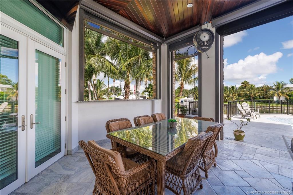 2346 Northwest Fork Road Stuart, FL 34994 - Photo 66 of 100 a dining room with furniture and outdoor view