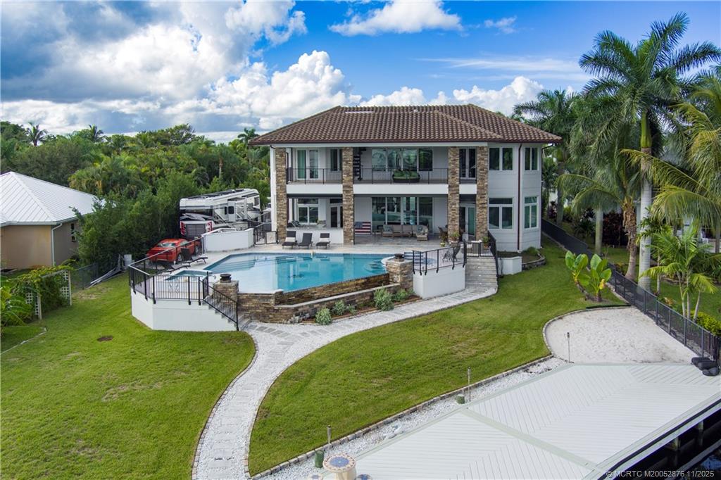 2346 Northwest Fork Road Stuart, FL 34994 - Photo 73 of 100 a view of a house with a yard patio and swimming pool