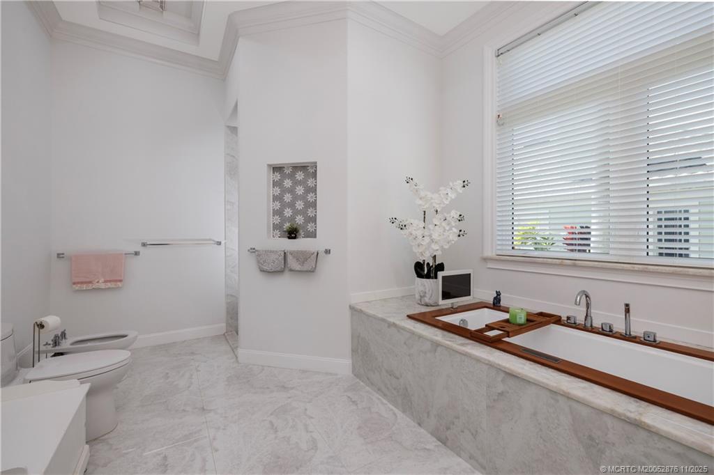 2346 Northwest Fork Road Stuart, FL 34994 - Photo 83 of 100 a bathroom with a tub sink and mirror