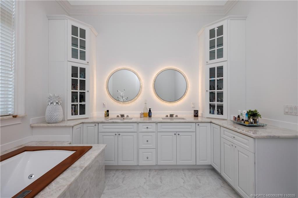 2346 Northwest Fork Road Stuart, FL 34994 - Photo 88 of 100 a bathroom with a double vanity sink and a bathtub