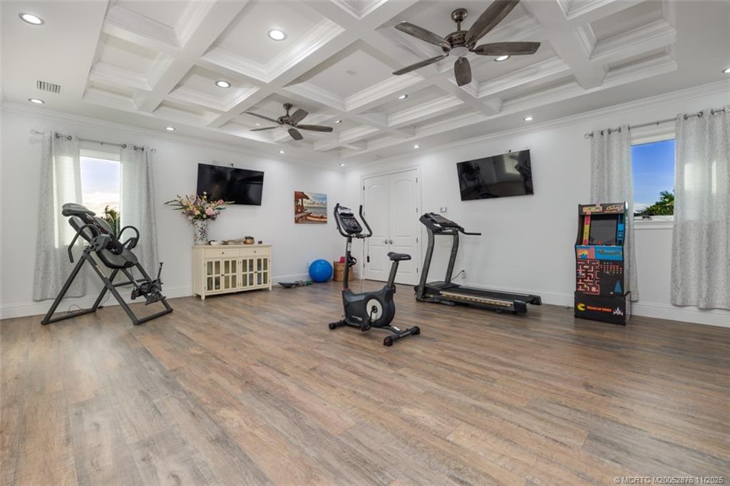 2346 Northwest Fork Road Stuart, FL 34994 - Photo 89 of 100 a view of a livingroom with gym equipment and a flat screen tv