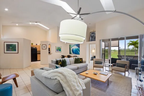 a living room with furniture and a chandelier