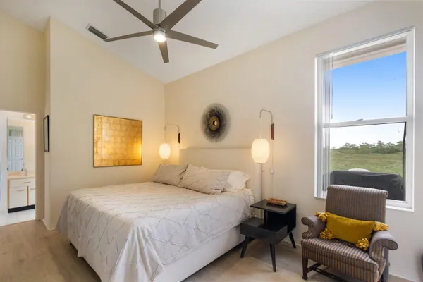 a bedroom with a bed and balcony view