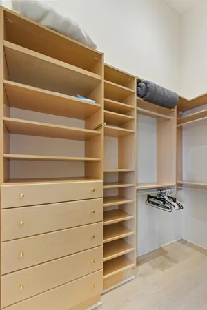 a view of walk in closet with empty racks