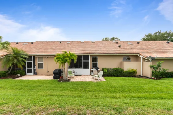a view of a house with a backyard