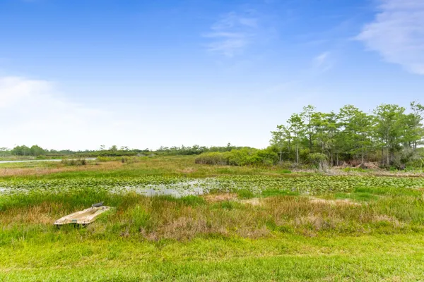 a view of a lake with houses in the background