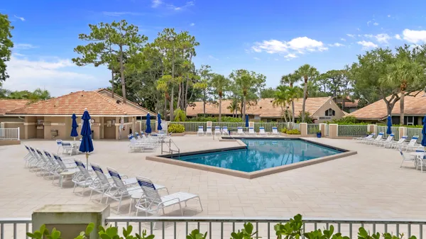 a view of a swimming pool with outdoor seating