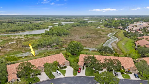 an aerial view of residential houses with outdoor space and ocean view