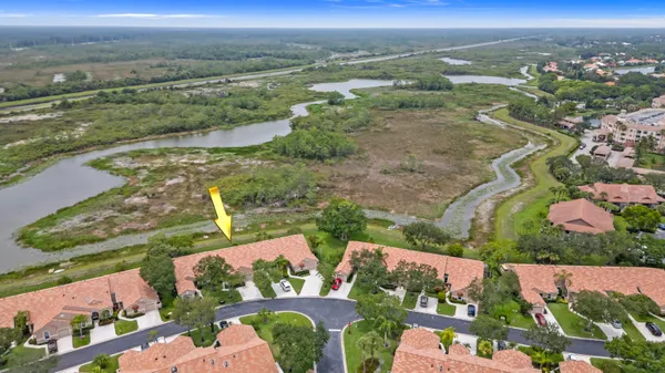 an aerial view of lake and residential houses with outdoor space