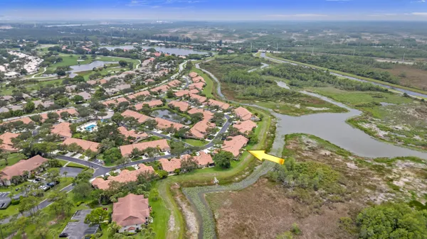 an aerial view of a houses with a yard