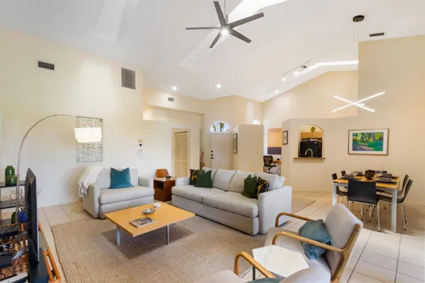 a living room with furniture and a wooden floor