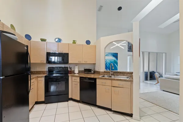 a kitchen with a stove top oven and refrigerator