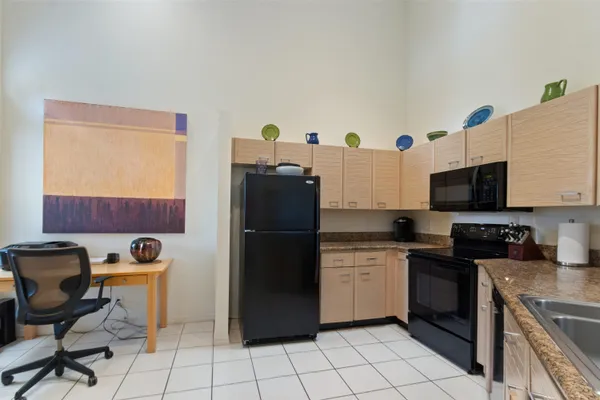 a kitchen with a refrigerator a stove a sink and a counter top space