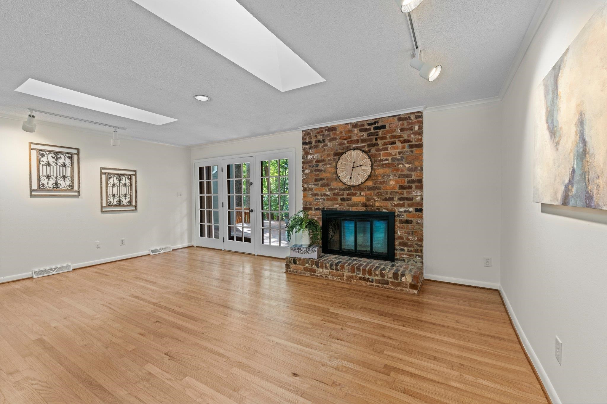 4505 Eliot Place Raleigh, NC 27609 - Photo 4 of 51 Family Room with brick surround wood burning fireplace. Family Room