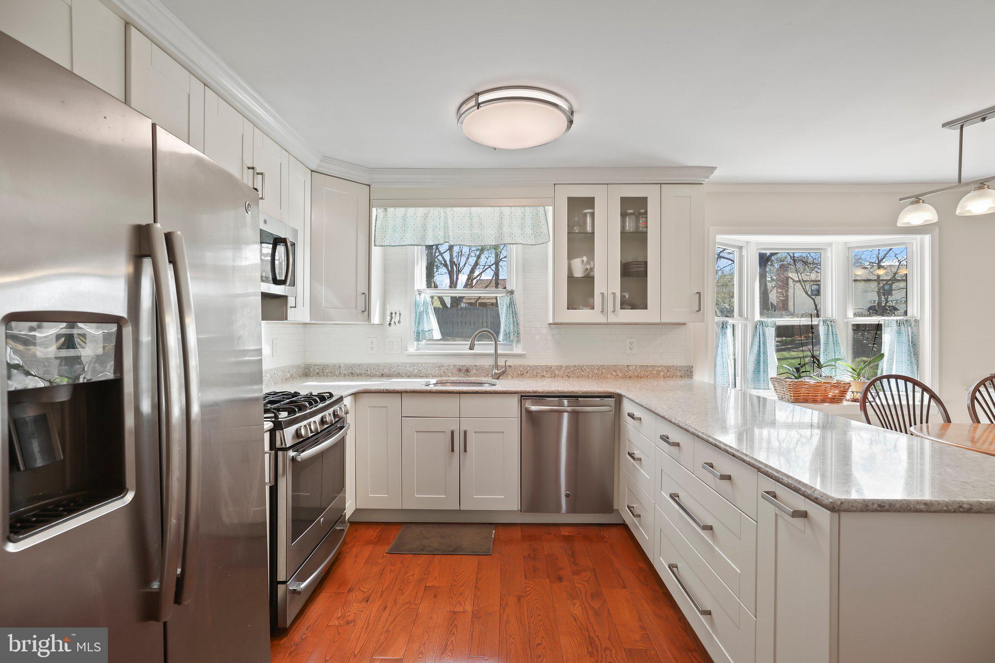 876 Henry Drive Yardley, PA 19067 - Photo 13 of 65 a kitchen with stainless steel appliances granite countertop a sink stove and refrigerator