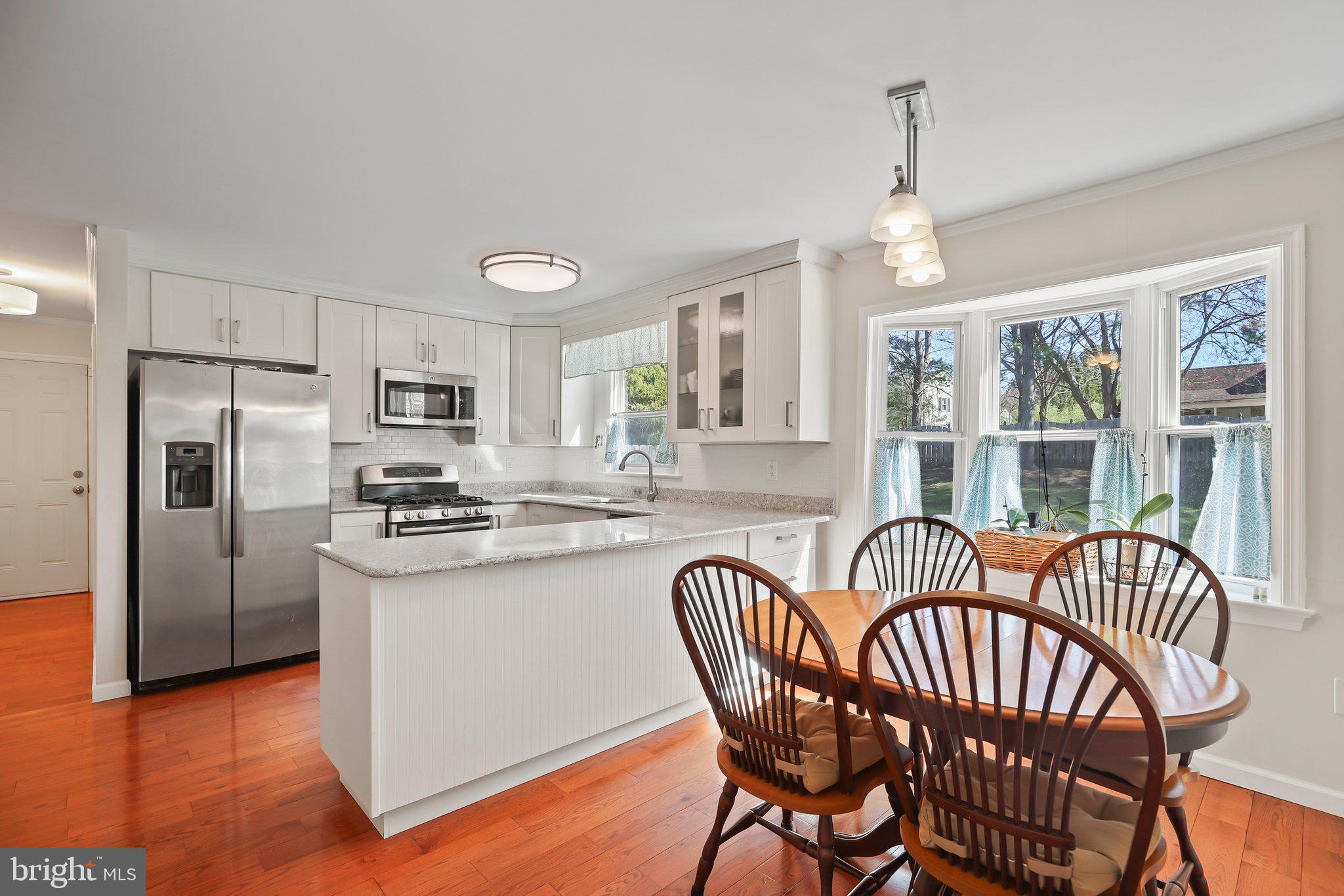 876 Henry Drive Yardley, PA 19067 - Photo 16 of 65 a view of a dining room with furniture window and wooden floor