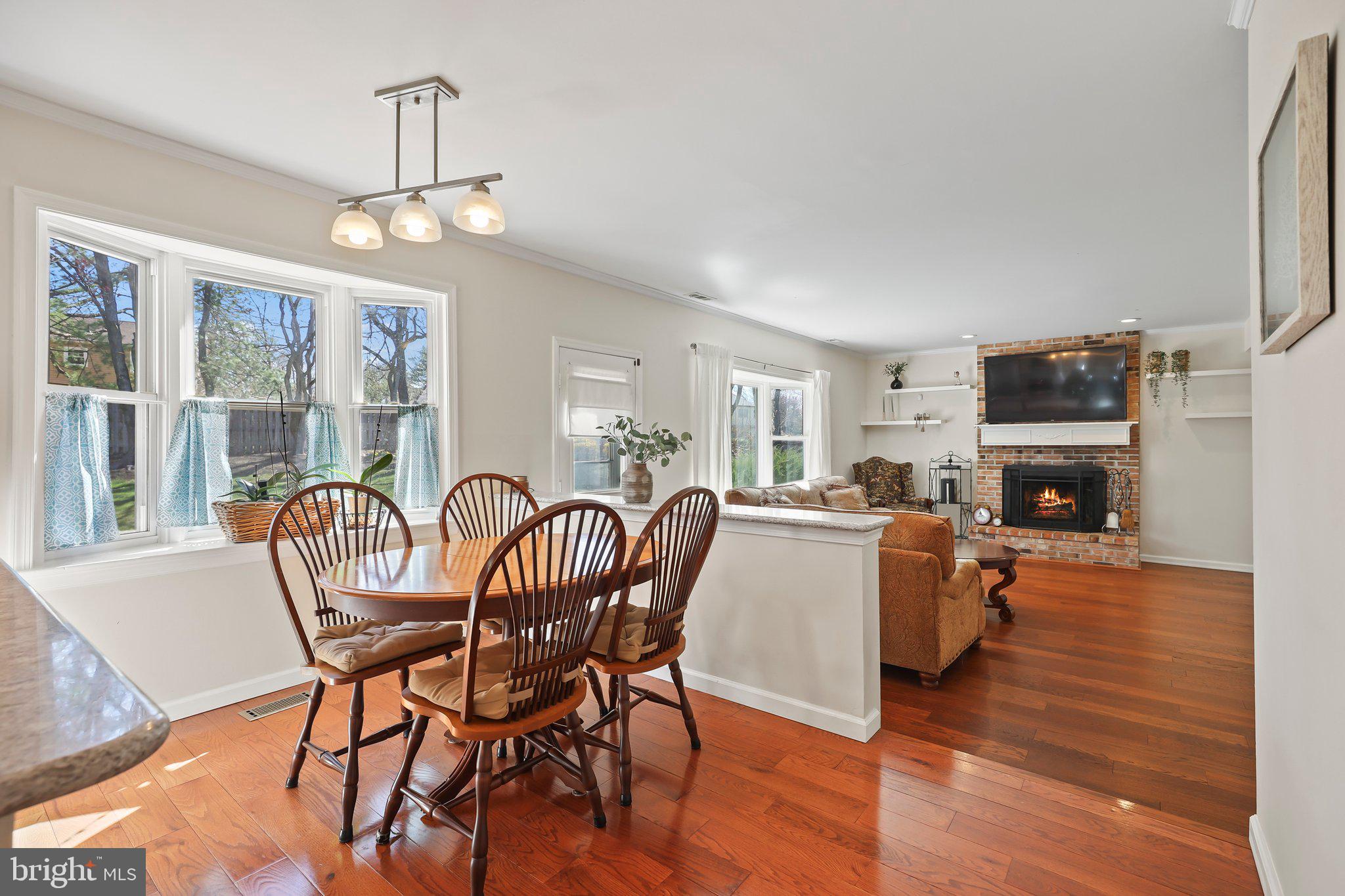 876 Henry Drive Yardley, PA 19067 - Photo 17 of 65 a dining room with furniture a chandelier and wooden floor