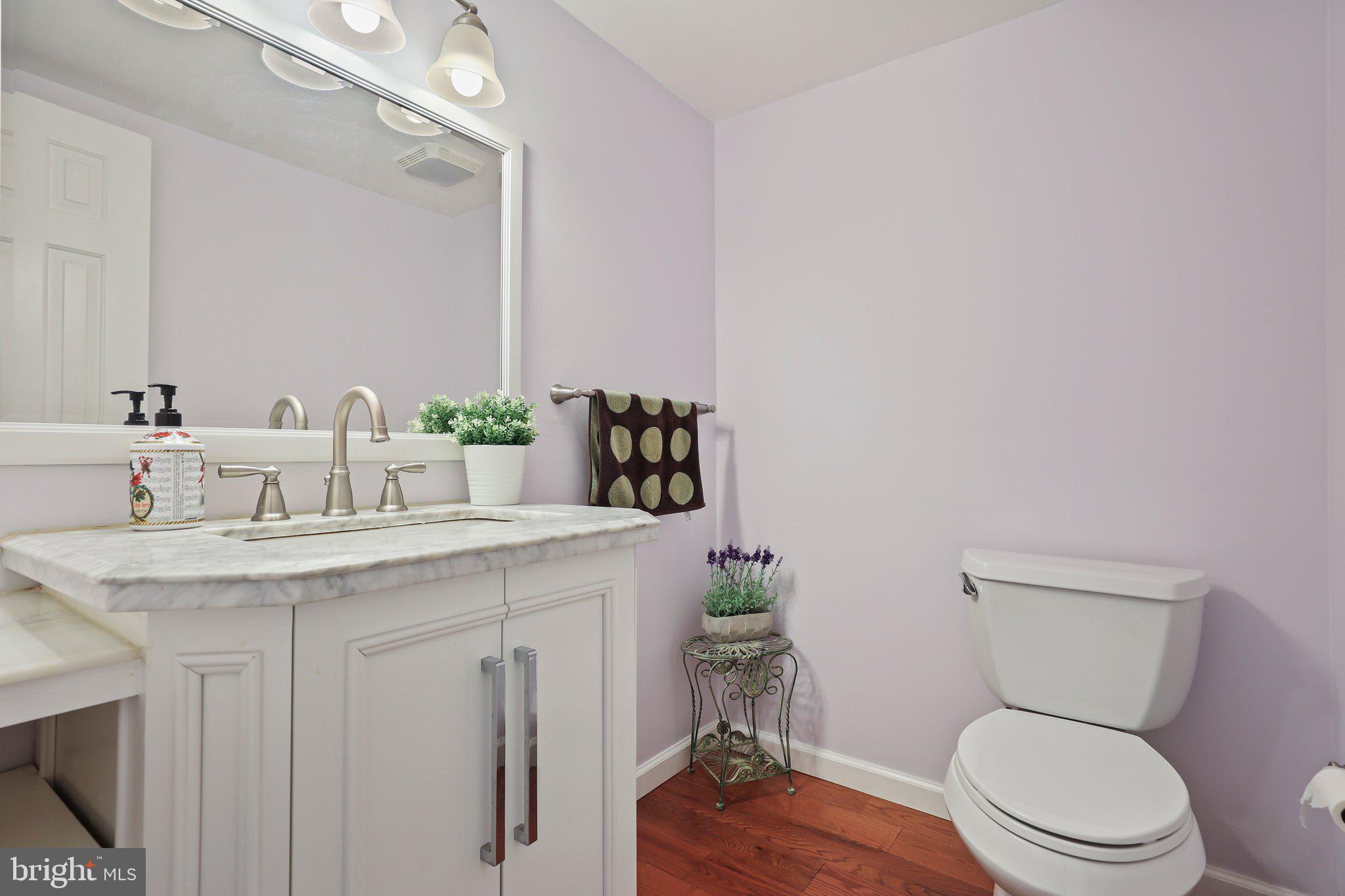 876 Henry Drive Yardley, PA 19067 - Photo 20 of 65 a bathroom with a granite countertop toilet sink and mirror