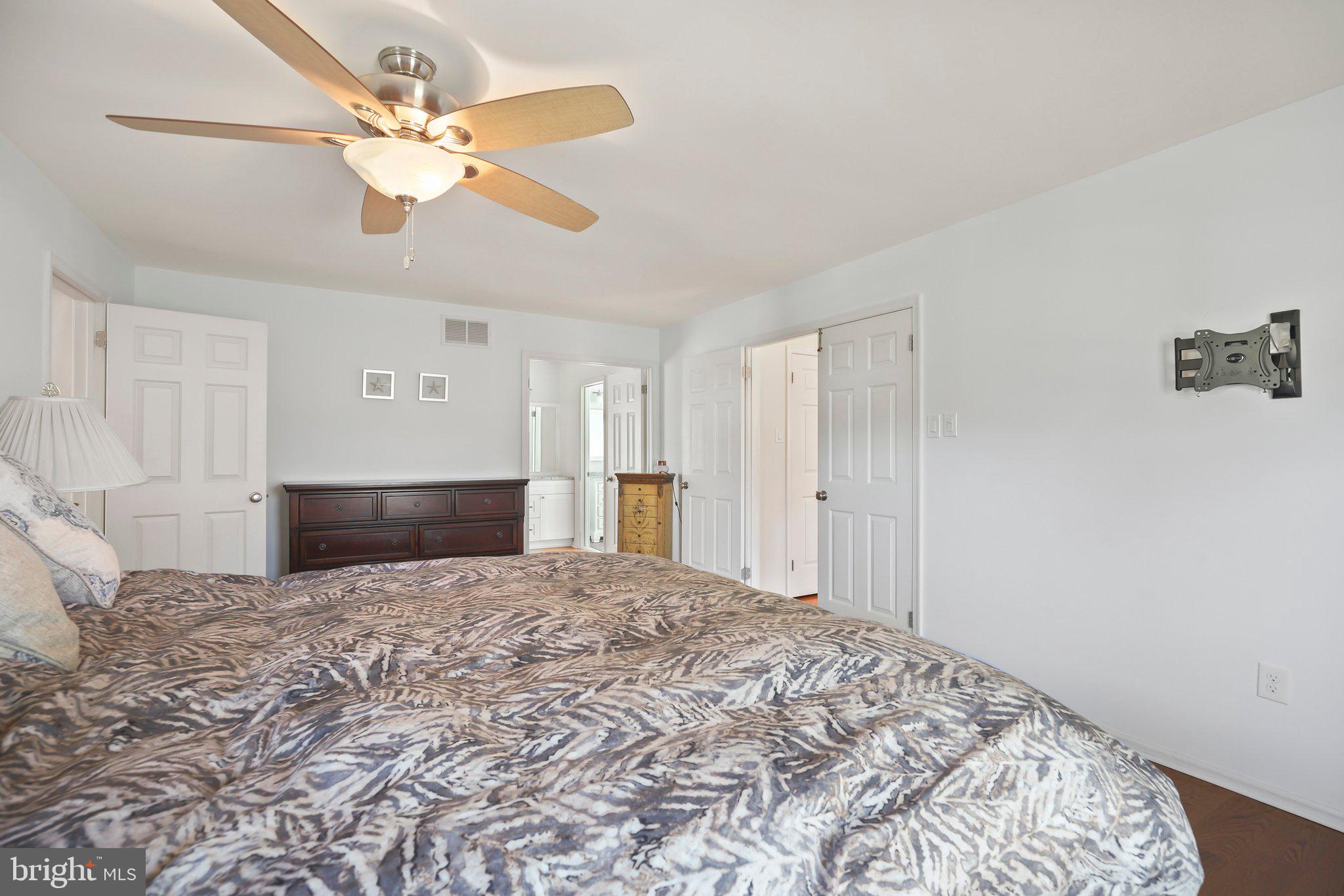 876 Henry Drive Yardley, PA 19067 - Photo 25 of 65 a view of a bedroom with a bed and a chandelier