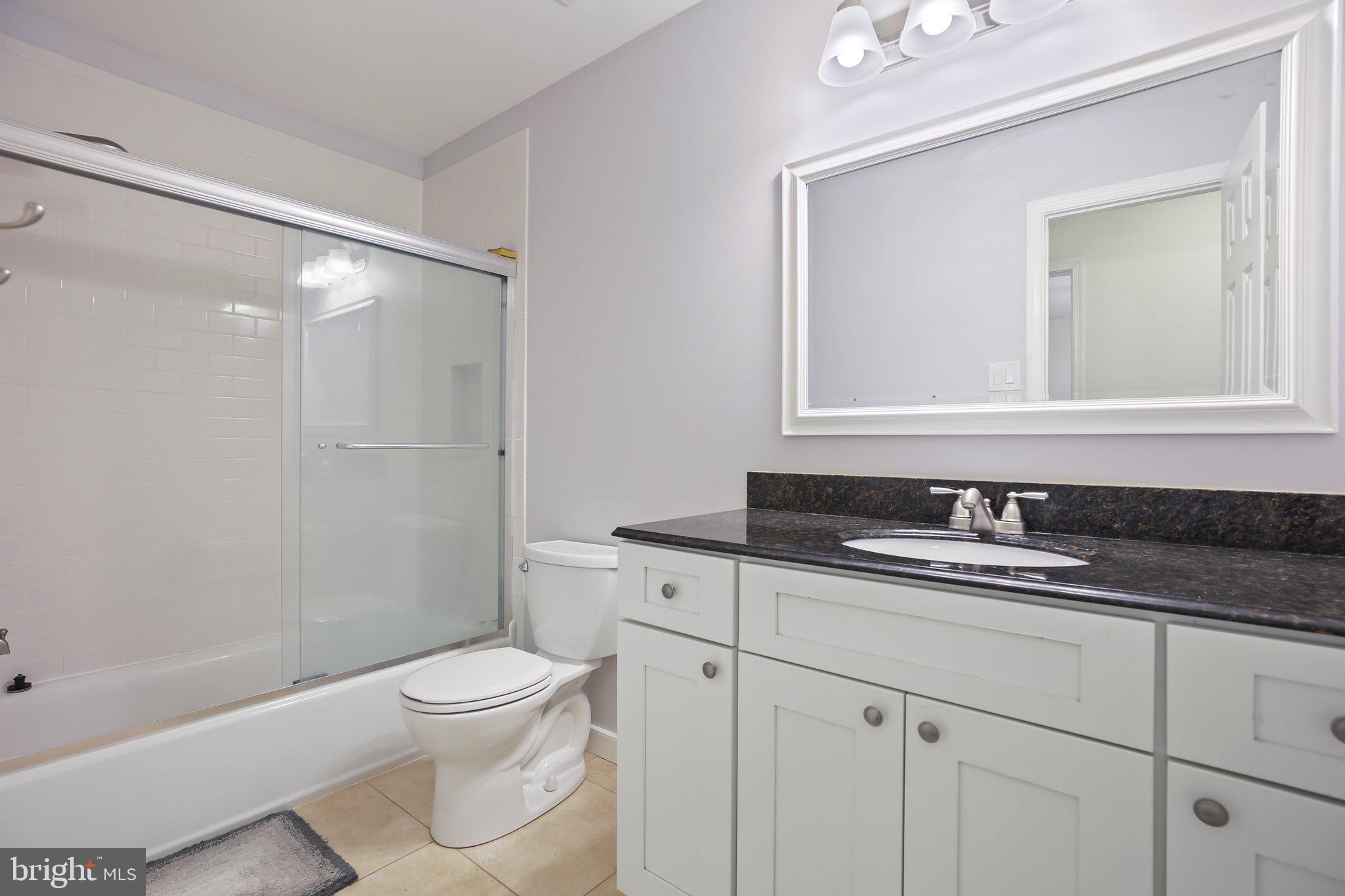 876 Henry Drive Yardley, PA 19067 - Photo 35 of 65 a bathroom with a granite countertop toilet sink and mirror