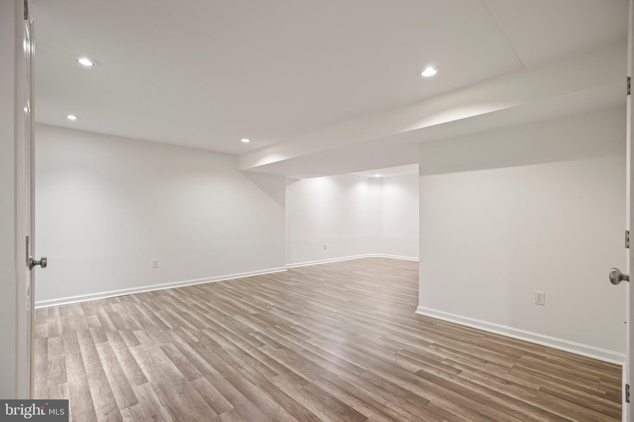 876 Henry Drive Yardley, PA 19067 - Photo 38 of 65 an empty room with wooden floor and windows