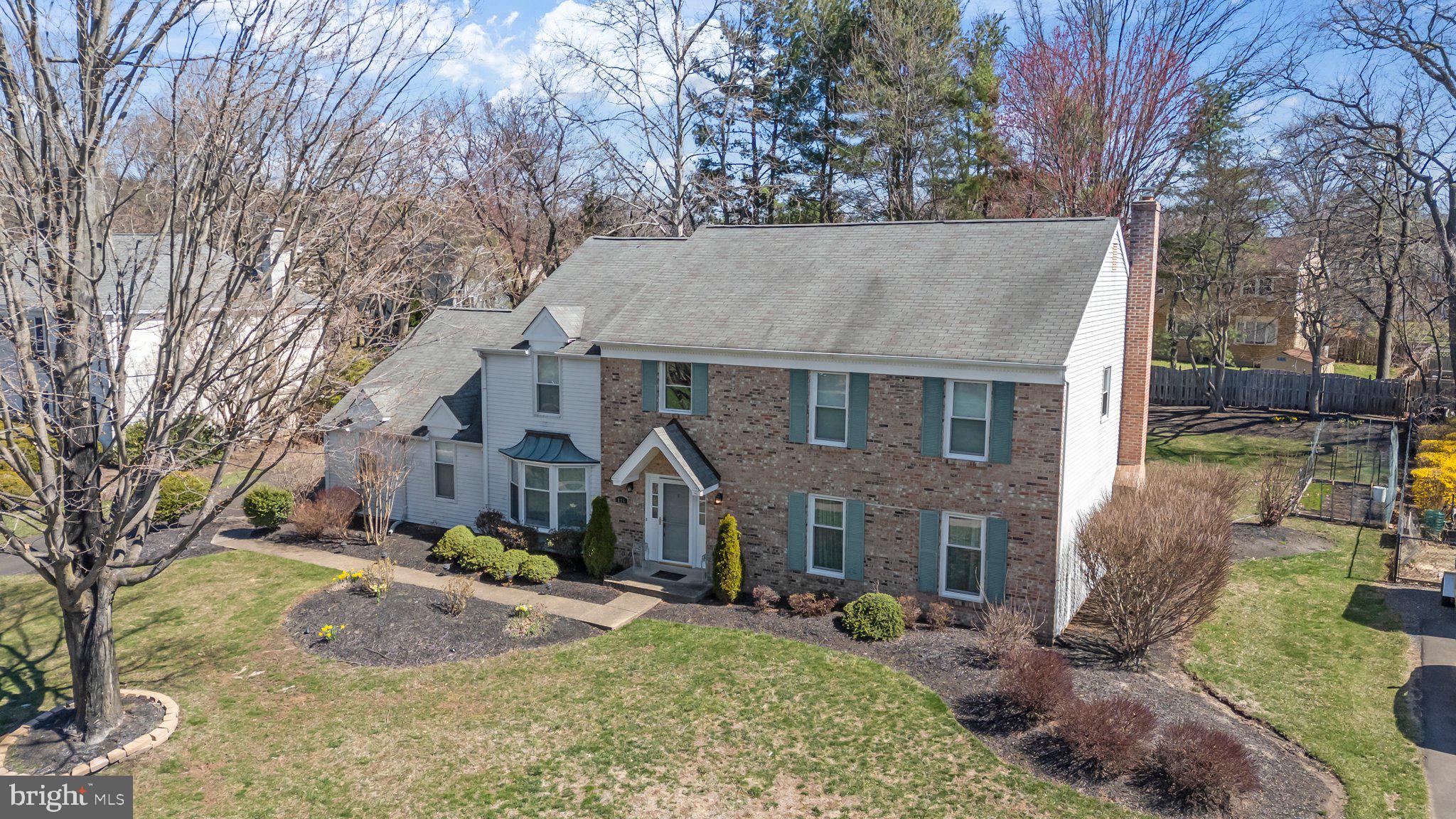 876 Henry Drive Yardley, PA 19067 - Photo 51 of 65 a view of a white house with a yard and large tree