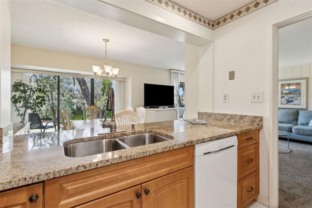 2004 Beachwood Road, Unit 2004 Fernandina Beach, FL 32034 - Photo 20 of 54 a kitchen with a sink and a large mirror
