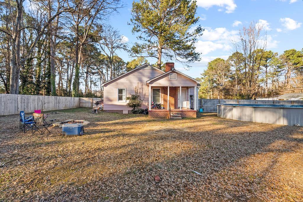 a view of a house with backyard and sitting area