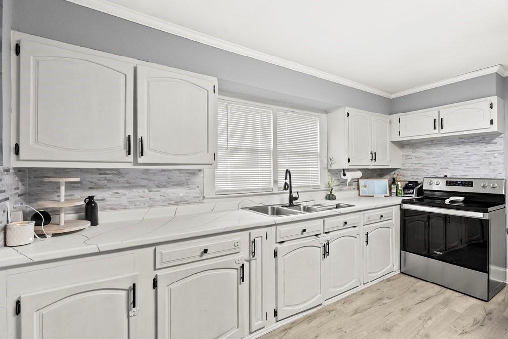 601 Juniper Avenue Dalton, GA 30721 - Photo 12 of 18 a kitchen with white cabinets sink and appliances