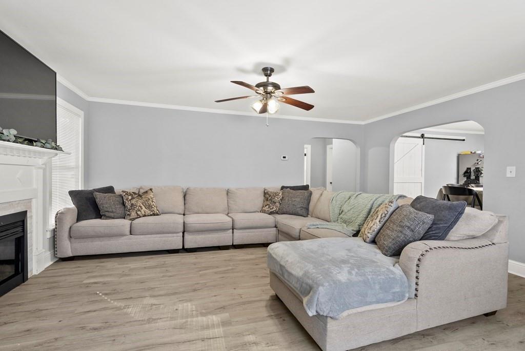 601 Juniper Avenue Dalton, GA 30721 - Photo 17 of 18 a living room with furniture a fireplace and a flat screen tv