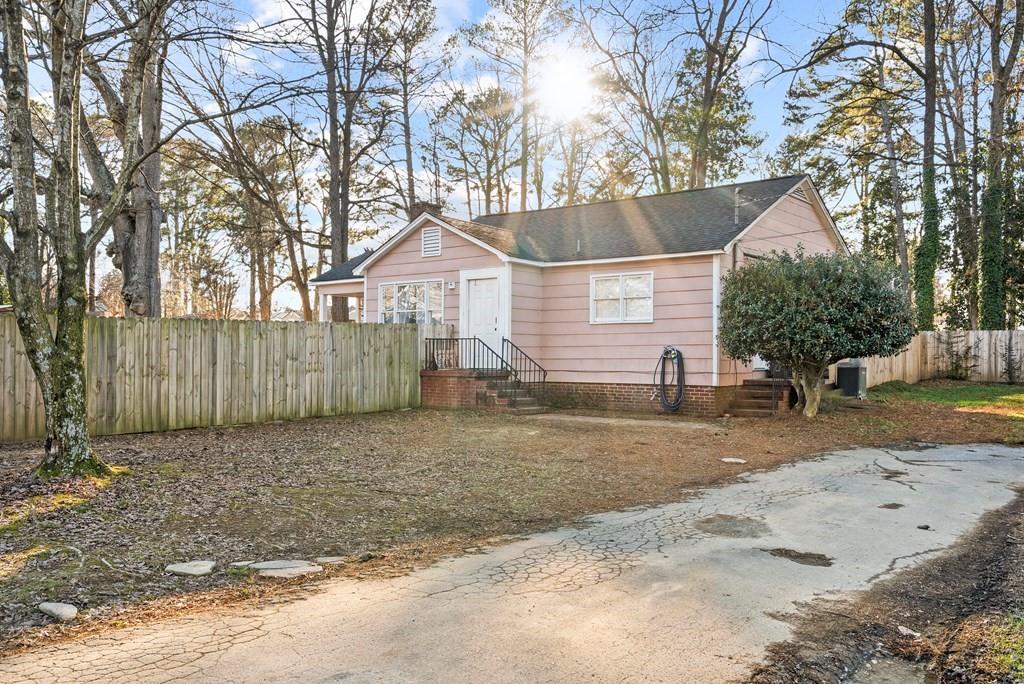 601 Juniper Avenue Dalton, GA 30721 - Photo 2 of 18 a view of a white house next to a yard with a large tree